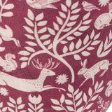 Close-up of the Skandi Woodland Animal Velvet Door Stop in berry, showing cream folk-art print of hares, a leaping stag, squirrels and birds among leafy branches on soft velvet.