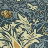 Close-up of Snakeshead Floral polyester cushion fabric in indigo, cream and gold, showing scrolling leaf and tulip pattern detail.