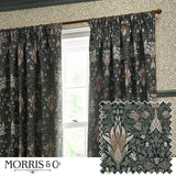 Snakeshead Jacquard Chenille pencil pleat curtains in Indigo/Leaf, floral fritillary pattern, hung by a window beside patterned wallpaper, with a fabric swatch shown inset.