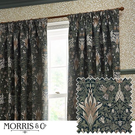 Snakeshead Jacquard Chenille pencil pleat curtains in Indigo/Leaf, floral fritillary pattern, hung by a window beside patterned wallpaper, with a fabric swatch shown inset.