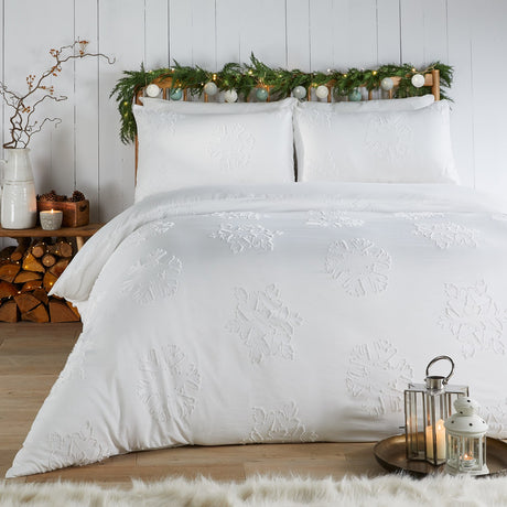 White Snow Crystal duvet cover set with tufted snowflake motifs and matching pillowcases, shown on a bed in a festive bedroom setting.