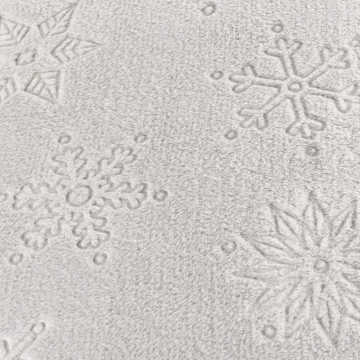 Close-up of the Snowflakes Polyester Faux Fur Cushion in grey, showing snowflake and star motifs textured into the soft pile fabric.