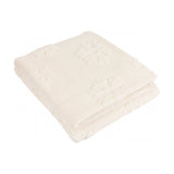 Folded snow white faux fur throw with raised snowflake pattern on a long-piled velvet surface, shown on a plain white background.