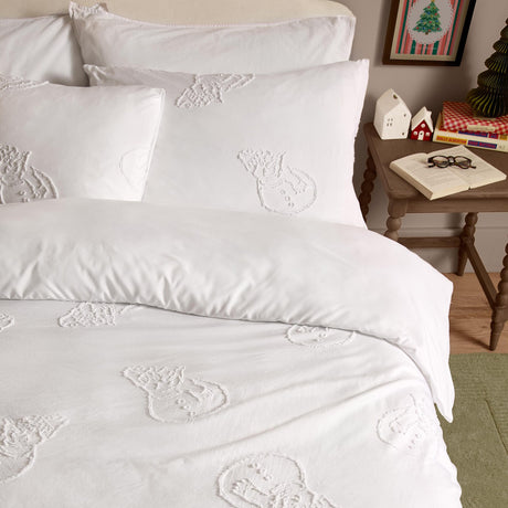 White duvet cover set with tufted snowmen design in raised white tufting, styled on a bed with matching pillowcases in a bedroom setting.