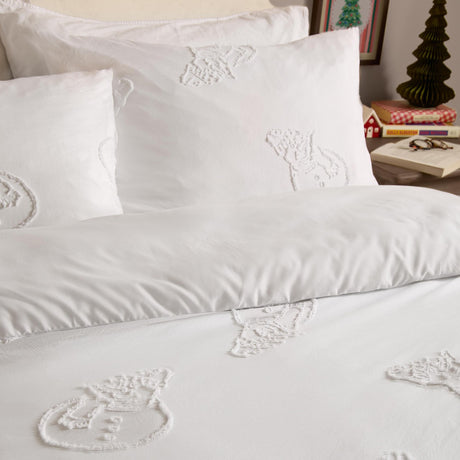 White polyester duvet cover set with tufted snowmen design in tone-on-tone raised texture, styled on a bed with matching pillowcases in a bedroom setting.