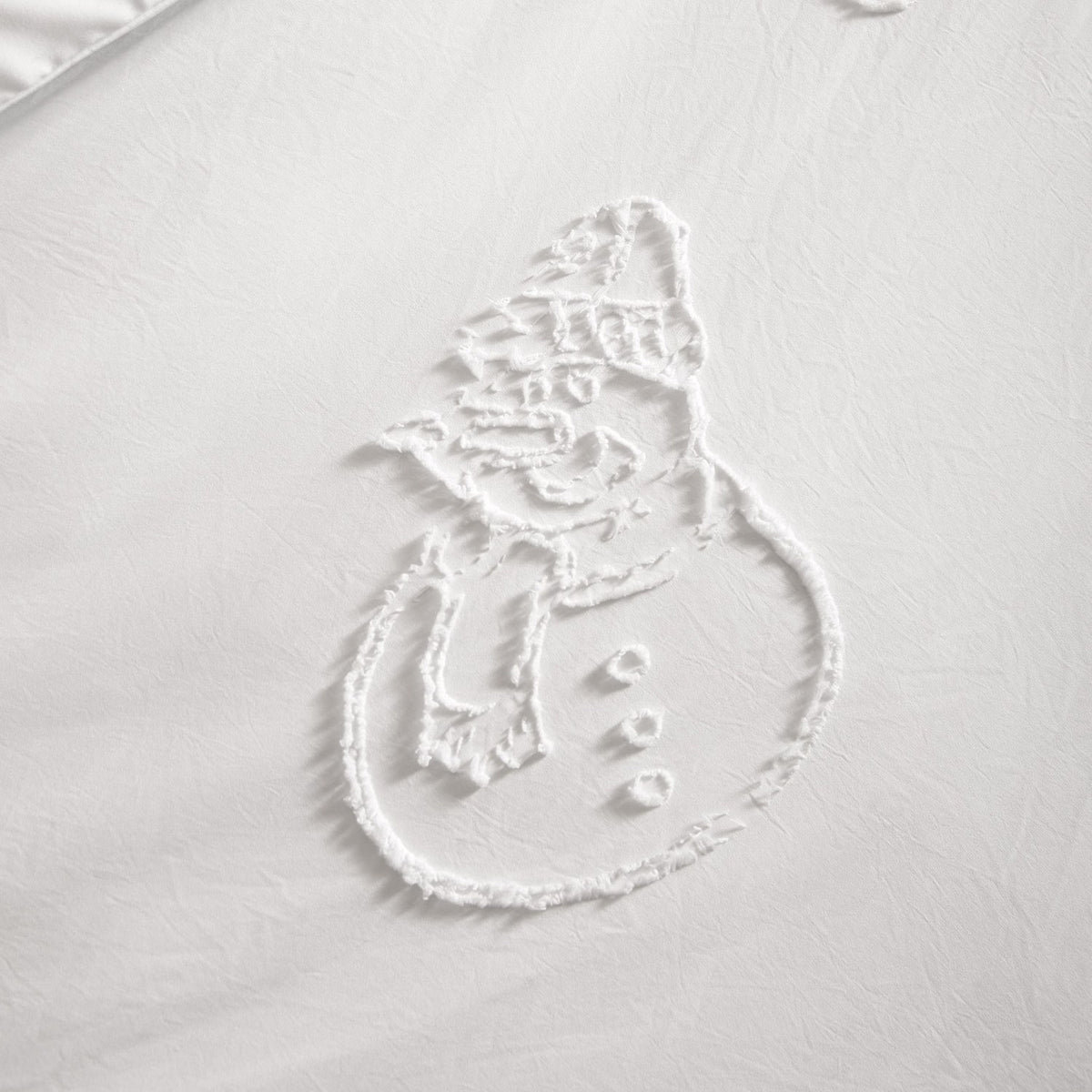 Close-up of the Snowmen Tufted Polyester Duvet Cover Set in white, showing a raised tufted snowman design in a hat and scarf against a smooth white ground.
