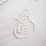 Close-up of the Snowmen Tufted Polyester Duvet Cover Set in white, showing a raised tufted snowman design in a hat and scarf against a smooth white ground.