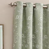 Sophia Jacquard Embroidered Eyelet Curtains in sage green, showing fabric with foxglove and floral leaf pattern, metal eyelets on a brushed steel pole against a pink wall.
