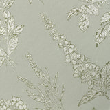 Close-up of the Sophia Eyelet Polyester Cushion in Sage, showing a jacquard-woven botanical pattern of foxgloves, roses and leaves in cream and olive on a sage fabric ground.