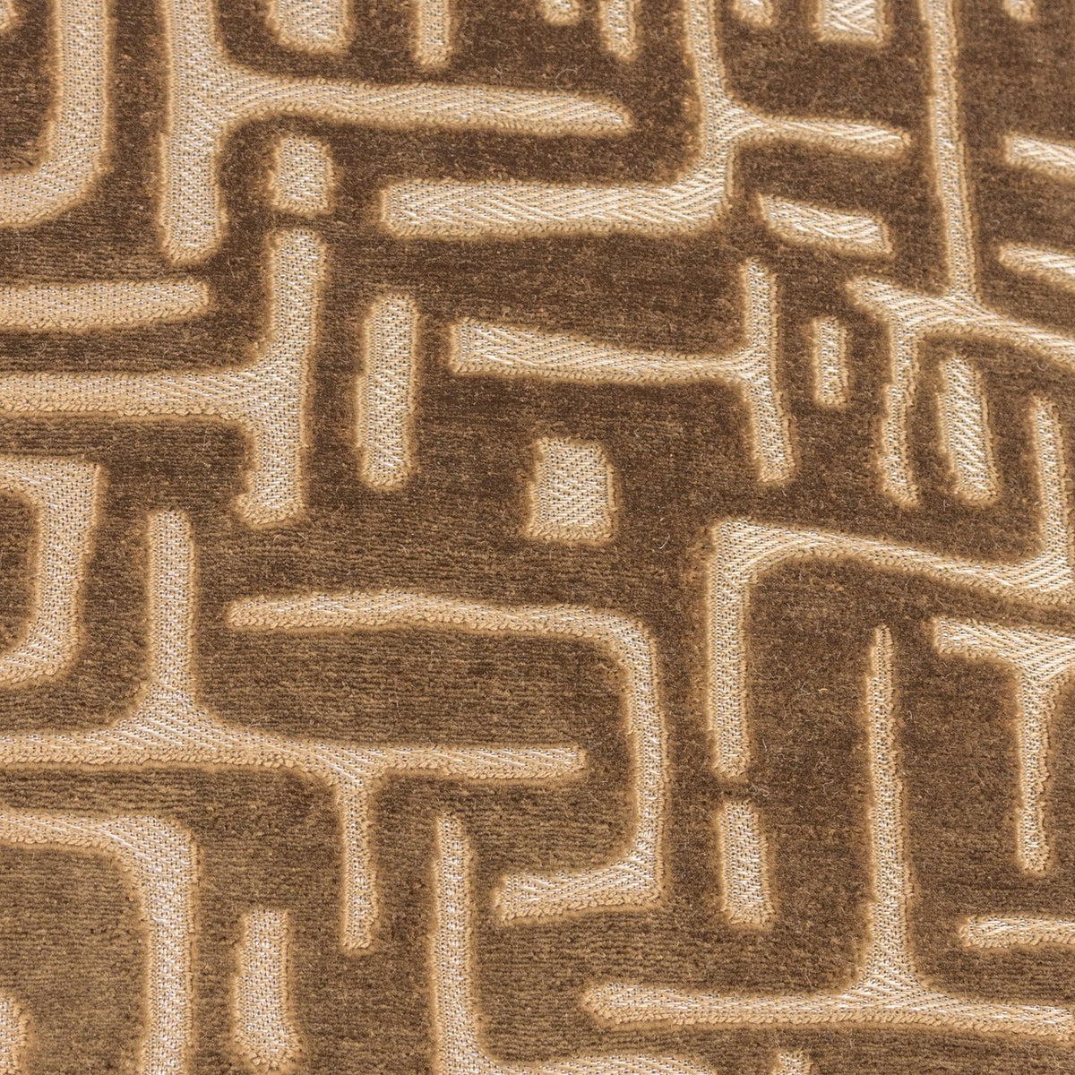 Soren Abstract Velvet Cushion in brown, close-up of the cut velvet pile showing a raised geometric maze pattern shifting from deep brown to soft gold.