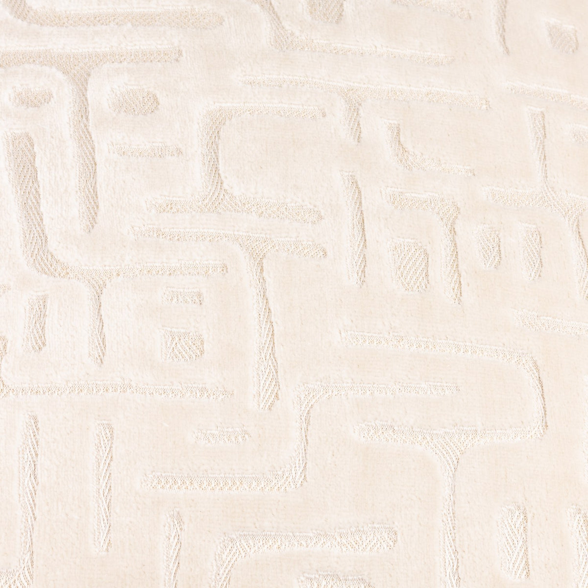 Close-up of the Soren Abstract Velvet Cushion in Chalk, showing cut velvet pile sculpted into a raised geometric maze-like pattern in cream tones.