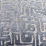 Close-up of the Soren Abstract Velvet Cushion in slate blue, showing raised cut-velvet geometric lines against a flatter woven ground.