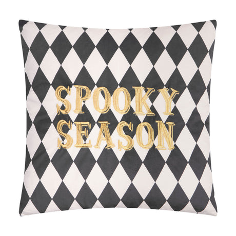 Square velvet cushion in black and white harlequin diamond print, with "Spooky Season" embroidered in raised gold lettering, shown on a plain white background.