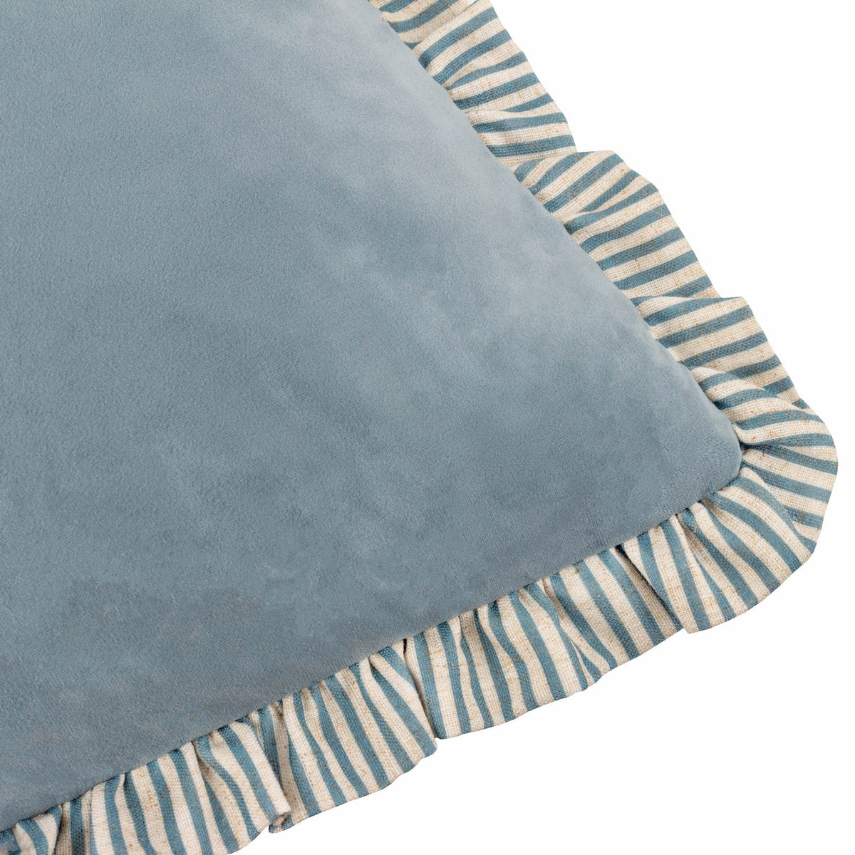 Close-up of the Solene Ruffle Velvet Linen Cushion in dusky blue, showing the plain velvet face with a blue and cream striped linen-blend ruffle trim on a white background.