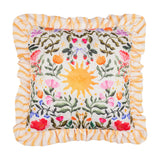 Summer Solstice square cushion with ruffled yellow wave-stripe trim, cream front printed with a central sun, foliage, poppies, strawberries and coloured bows, on a white background.