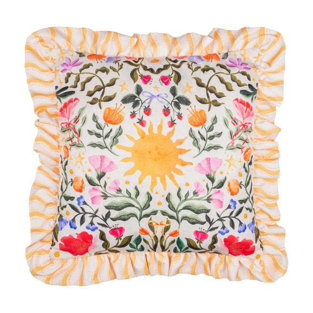 Summer Solstice square cushion with ruffled yellow wave-stripe trim, cream front printed with a central sun, foliage, poppies, strawberries and coloured bows, on a white background.