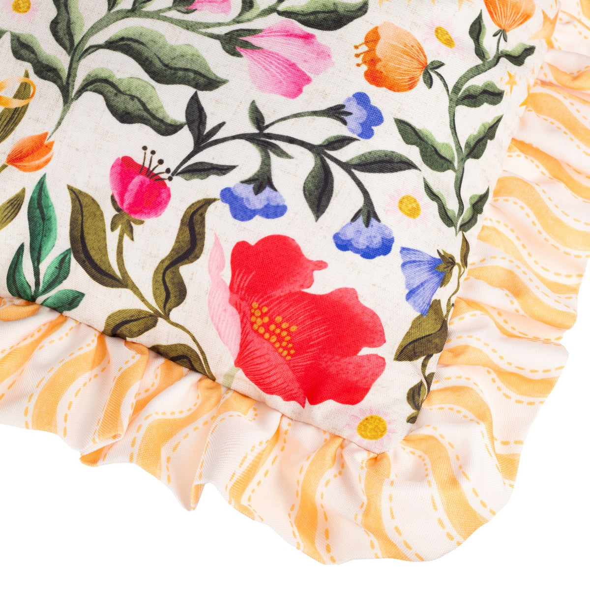 Close-up of the Summer Solstice reversible polyester cushion showing a cream floral corner with pink, red and blue blooms, edged in a yellow wavy-stripe ruffled trim.