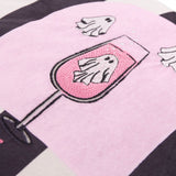 Close-up of the Spooky Spritz Striped Velvet Cushion in pink, showing embroidered ghost detail in a cocktail glass on a pink arch against black and white stripes.