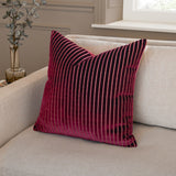 Savoy Stripe Polyester Velvet Cushion in burgundy with ribbed vertical stripes and metallic thread detail, shown on a beige sofa in a living room setting.