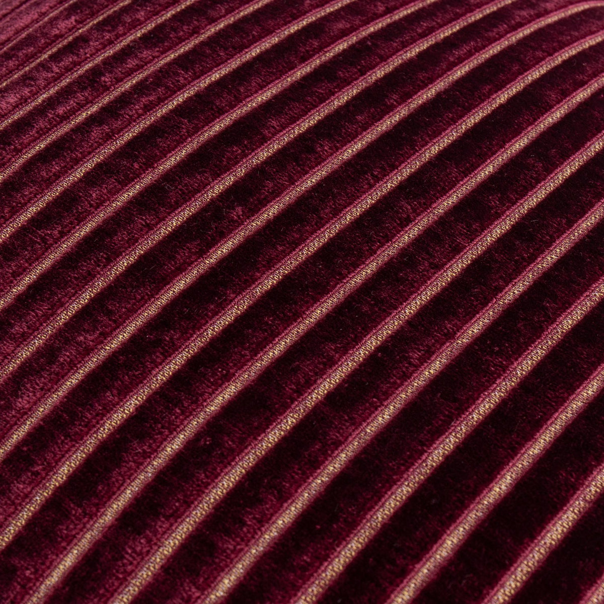 Close-up of the Savoy Stripe cushion in burgundy velvet, showing ribbed diagonal stripes with fine gold metallic threads between raised pile channels.