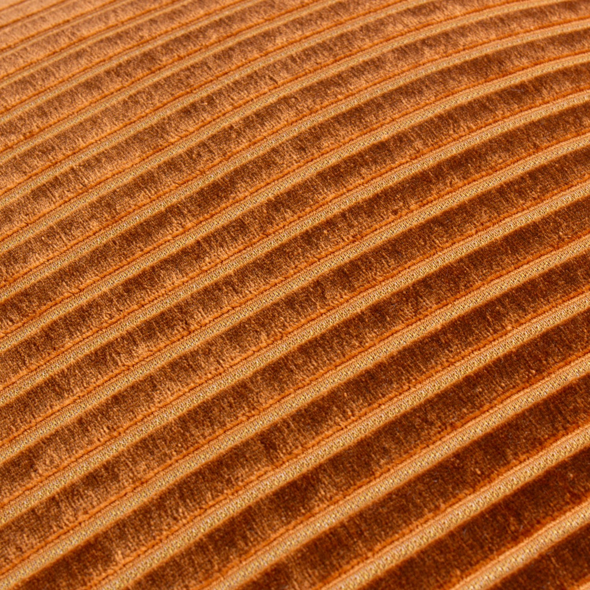 Close-up of the Savoy Stripe cushion's ridged velvet front, showing diagonal corded stripes in warm brick orange with light-catching texture.