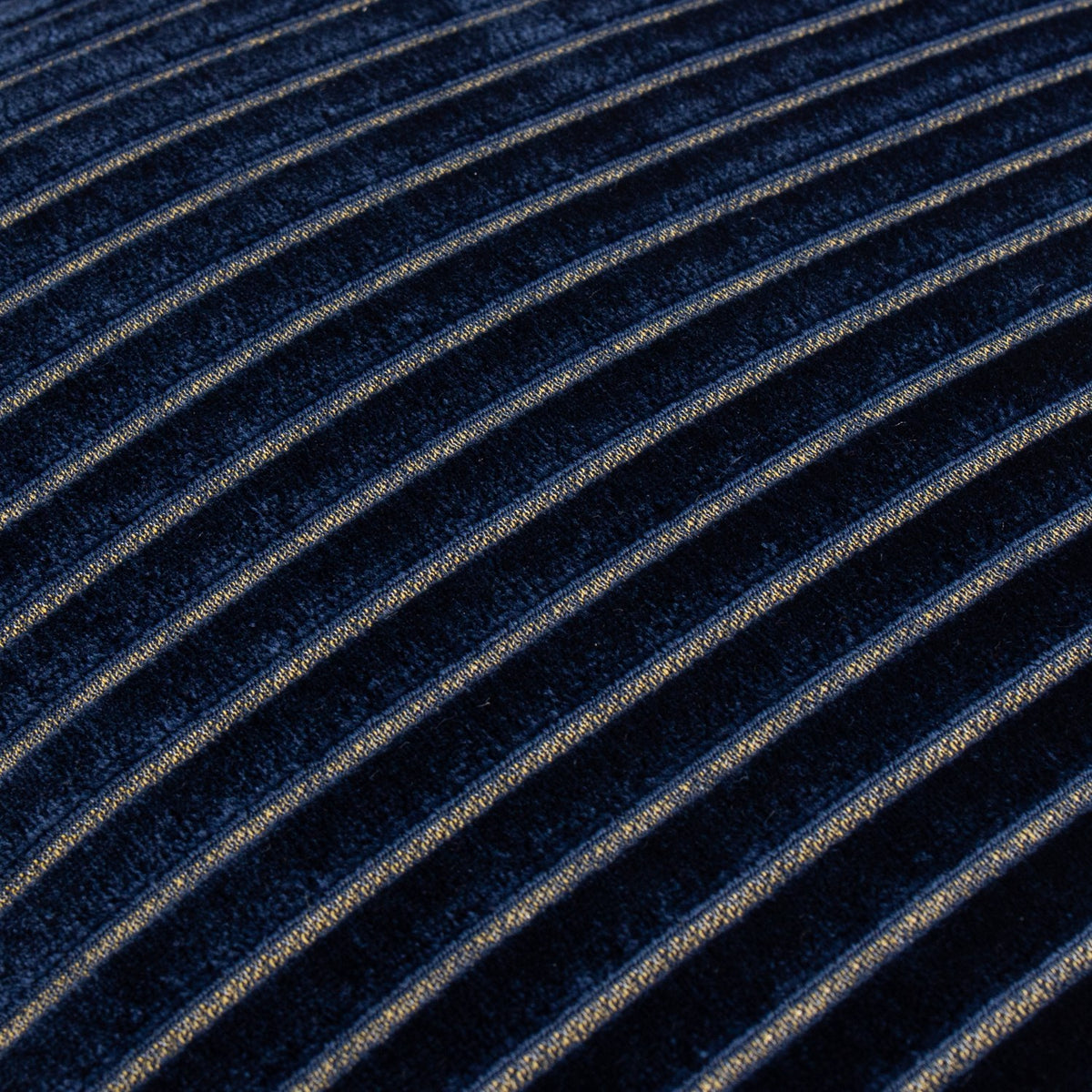 Close-up of the Savoy Stripe Polyester Velvet Cushion in navy, showing raised diagonal stripes in a contrasting yarn against a deep navy velvet pile.