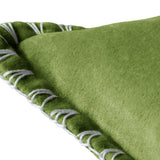 Close-up of the Stitch Plain Velvet Cushion in grass green, showing dense velvet pile and a pale contrast blanket-stitch edge, on a white background.