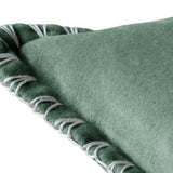 Close-up of the Stitch Plain Velvet Cushion in seafoam green velvet, showing the folded corner edge with hand-worked ivory blanket stitch trim on a white background.