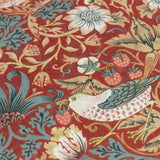 Close-up of the Strawberry Thief Floral Polyester Cushion in Berry, showing a bird, strawberries and floral trails in blue, cream and gold on a deep red ground.