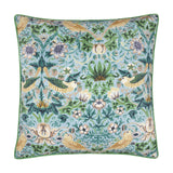 Square Strawberry Thief cushion in mineral-blue with yellow birds, cream flowers and green foliage print, finished with green piping, shown on a white background.