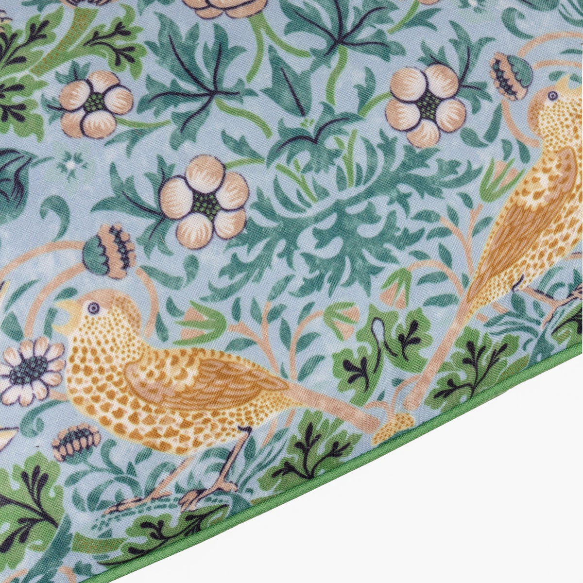 Strawberry Thief cushion corner, mineral-blue polyester fabric with golden thrushes, floral blossoms and green scrollwork, edged in a solid green border.