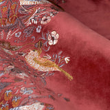 Close-up of Strawberry Thief pencil pleat curtains in berry red velvet, showing an embroidered leading edge with birds, strawberries and scrolling foliage.