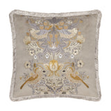 Square biscuit-beige velvet cushion with Strawberry Thief bird and foliage embroidery in gold, amber and grey tones, finished with matching fringe trim, on a white background.