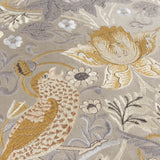 Close-up of Strawberry Thief Jacquard Velvet Cushion in biscuit, showing embroidered bird, florals and foliage in gold, amber and grey on matt velvet.