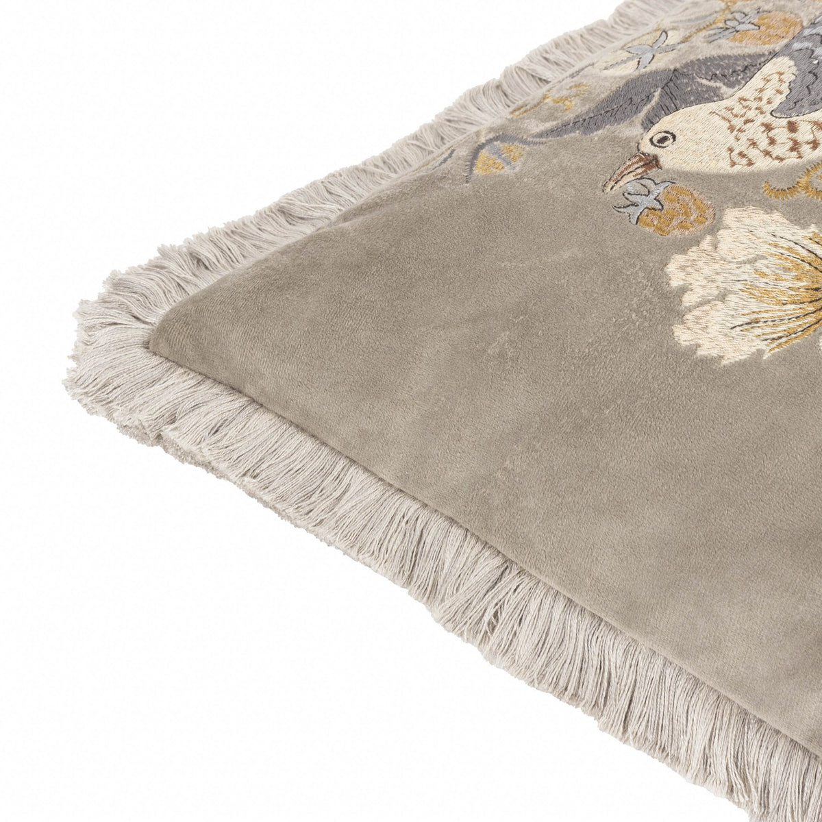 Strawberry Thief Jacquard Velvet Cushion in biscuit-beige, corner view showing fringed edging and embroidered bird and foliage detail on matt velvet, set against a plain white background.