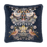 Strawberry Thief Jacquard Velvet Cushion in indigo, square with fringed edging, embroidered mirrored bird and strawberry motif with florals on deep blue velvet, shown on a white background.