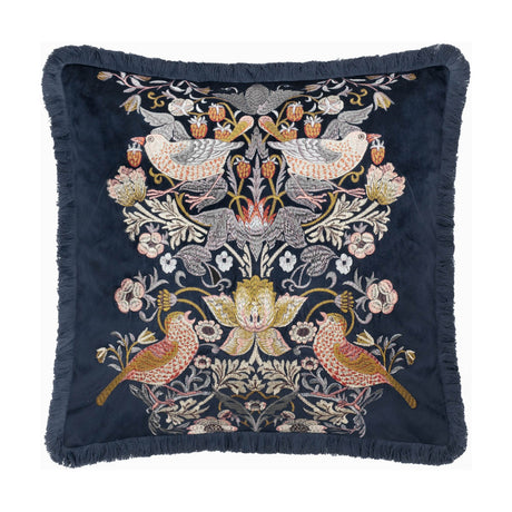 Strawberry Thief Jacquard Velvet Cushion in indigo, square with fringed edging, embroidered mirrored bird and strawberry motif with florals on deep blue velvet, shown on a white background.