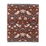 Strawberry Thief Jacquard Cotton Throw in berry-red, woven with bird, floral and strawberry motifs in blue, cream and brown, fringed edges, shown on a plain white background.