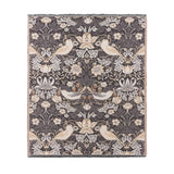 Strawberry Thief Jacquard Cotton Throw in Biscuit, showing birds, flowers and strawberries woven in cream and beige on a charcoal ground with fringed edges, on a plain white background.