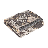 Folded Strawberry Thief jacquard cotton throw in charcoal, cream and biscuit tones with a fringed edge, shown on a plain white background.