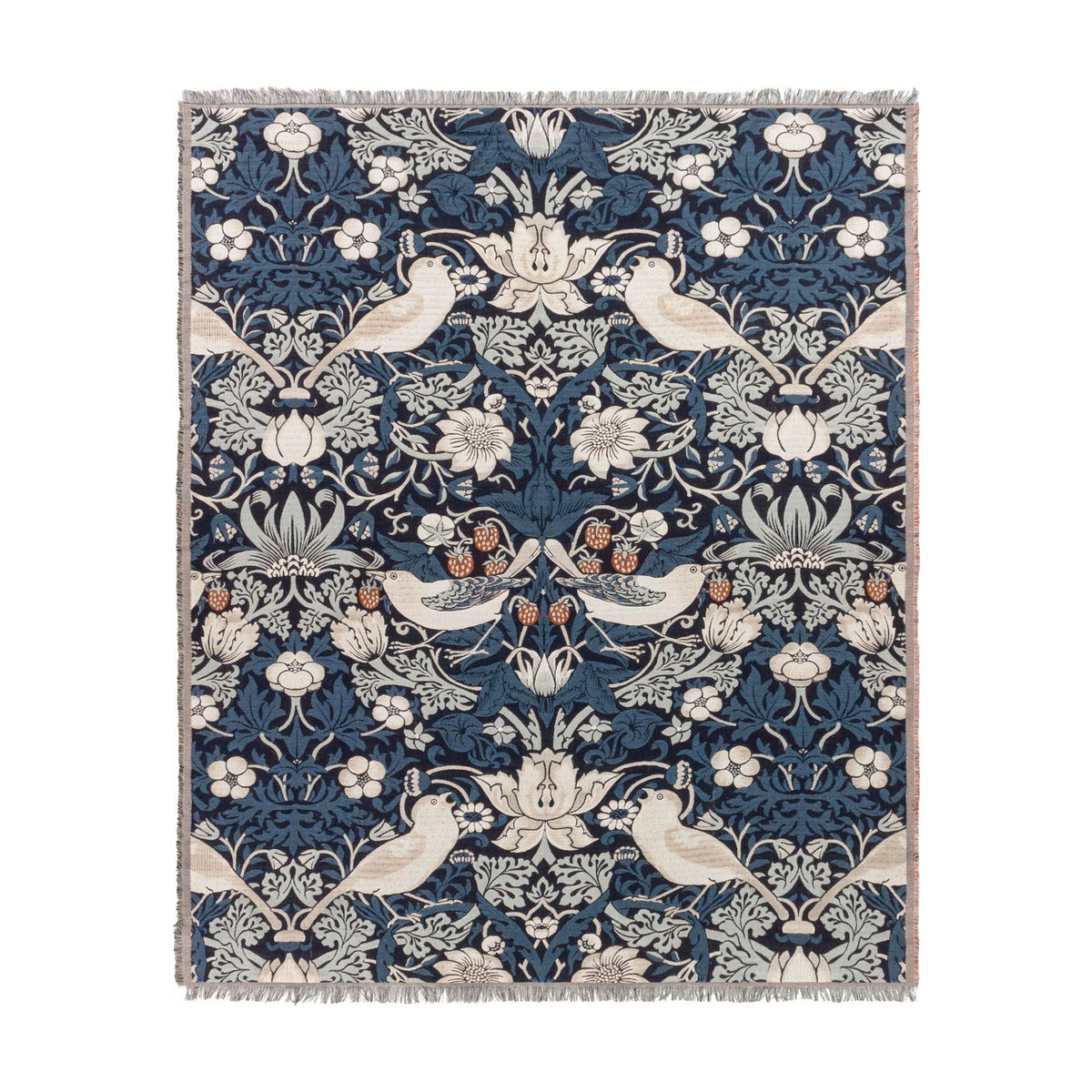 Strawberry Thief Jacquard Cotton Throw in indigo, woven with birds, strawberries and trailing floral motifs in cream, rust and blue tones, with fringed edges on a white background.