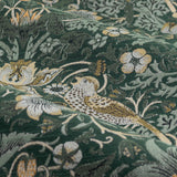 Close-up of Strawberry Thief pencil pleat curtains in forest green polyester, showing William Morris's bird, strawberry and foliage pattern in gold, cream and sage tones.