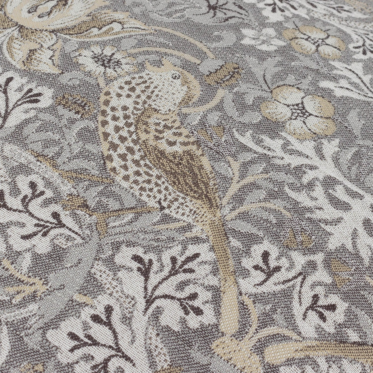 Close-up of Strawberry Thief jacquard velvet cushion in biscuit, showing woven bird, berry, and leaf pattern in grey, beige, and cream tones.
