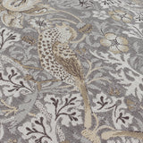 Close-up of Strawberry Thief jacquard velvet cushion in biscuit, showing woven bird, berry, and leaf pattern in grey, beige, and cream tones.