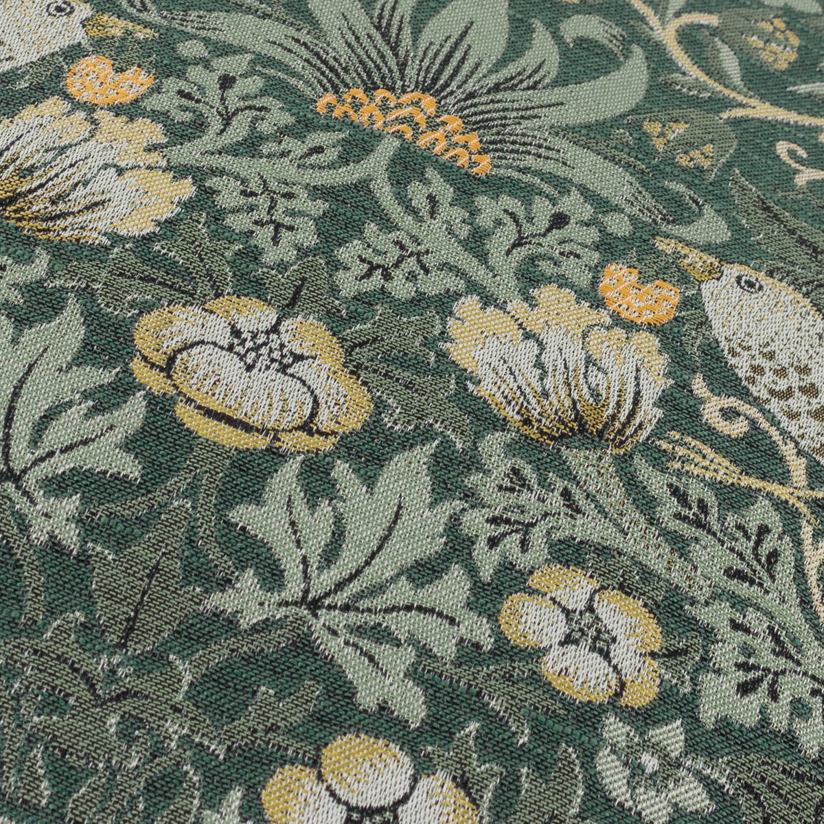 Close-up of Strawberry Thief jacquard velvet cushion in forest green, showing woven birds, flowers and leaves in cream, gold and amber thread detail.
