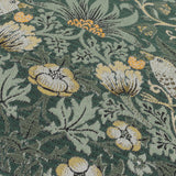 Close-up of Strawberry Thief jacquard velvet cushion in forest green, showing woven birds, flowers and leaves in cream, gold and amber thread detail.