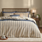 Selby waffle cotton striped duvet cover set in coal and natural on a bed with matching pillowcases, styled with blue accent bedding in a bedroom setting.