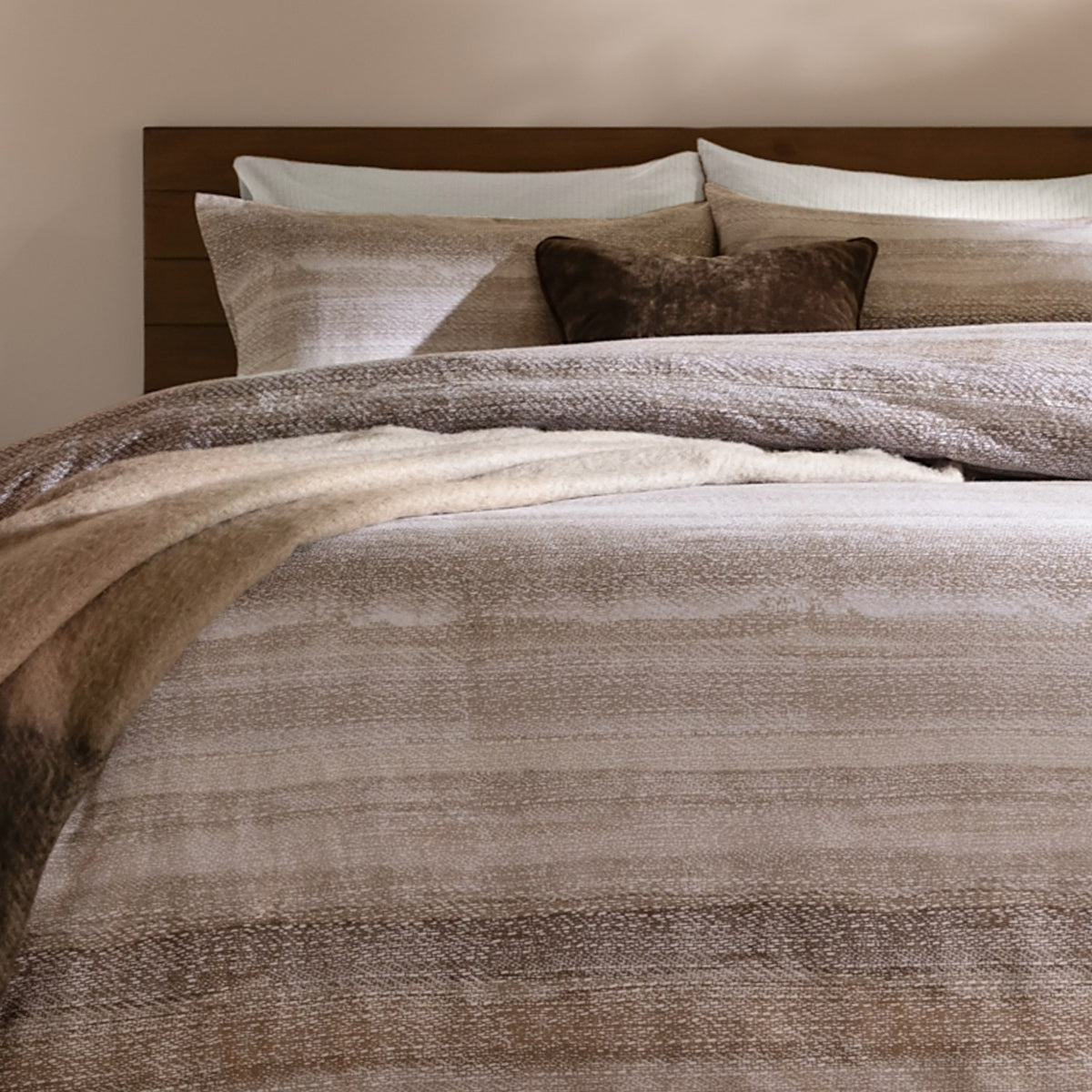 Swift Cotton Striped Duvet Cover Set in Natural, brushed cotton bedding with muted beige stripes, styled on a bed with a wooden headboard and brown accent cushions.