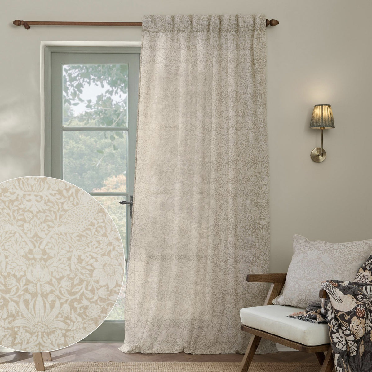 Strawberry Thief Floral Linen Curtain Panel in cream, hung by a window in a living room, with a fabric swatch inset showing the tonal bird and strawberry print.