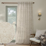 Strawberry Thief Floral Linen Curtain Panel in cream, hung by a window in a living room, with a fabric swatch inset showing the tonal bird and strawberry print.